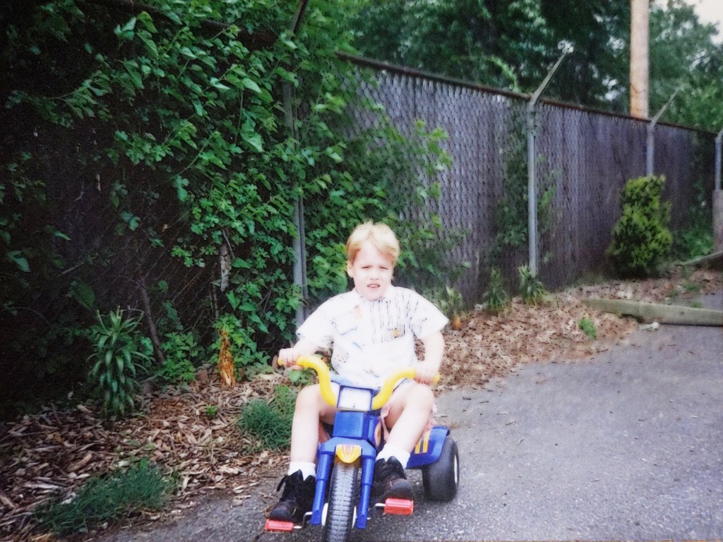young dan riding a big wheel

