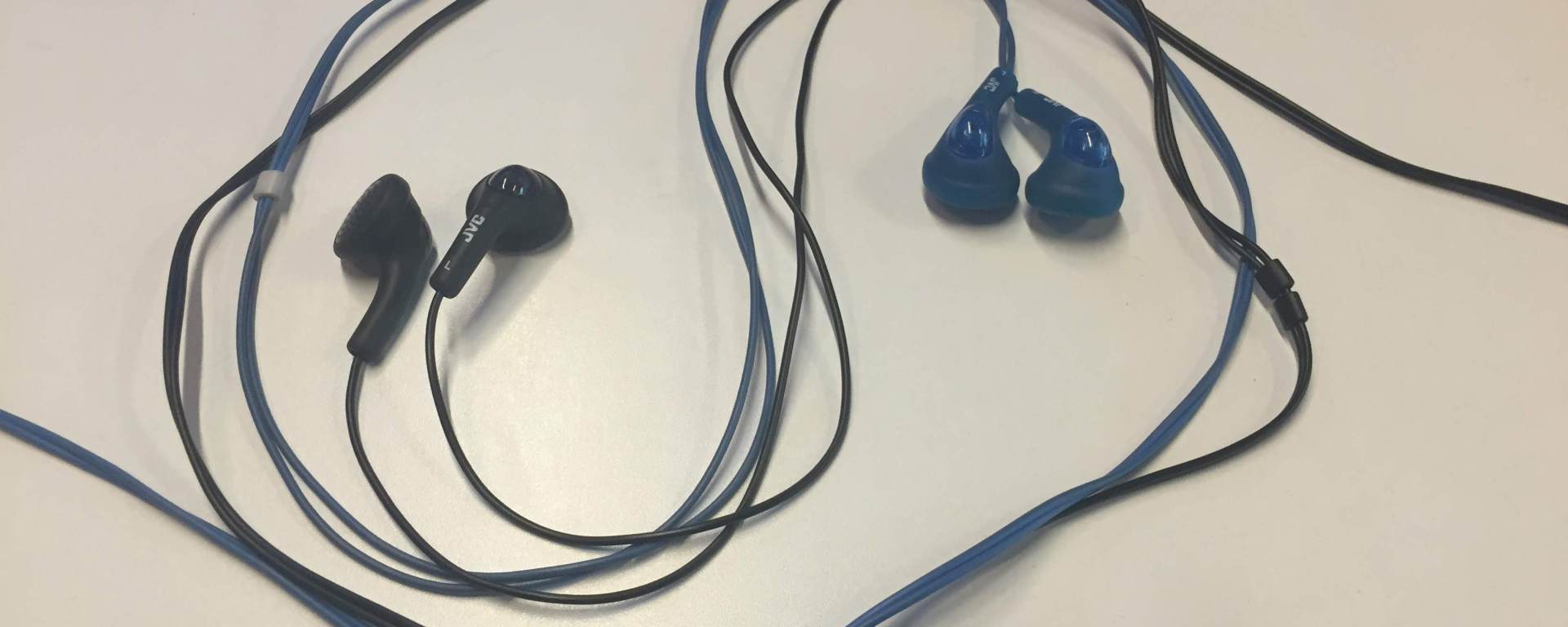yin yang symbol made with blue and black earbuds